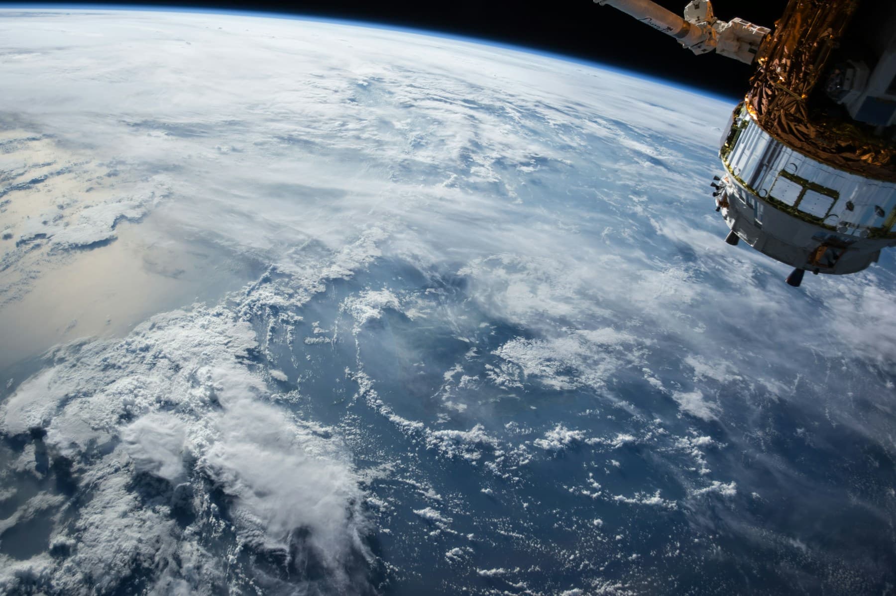 View of Earth's atmosphere and orbital hardware photographed from space